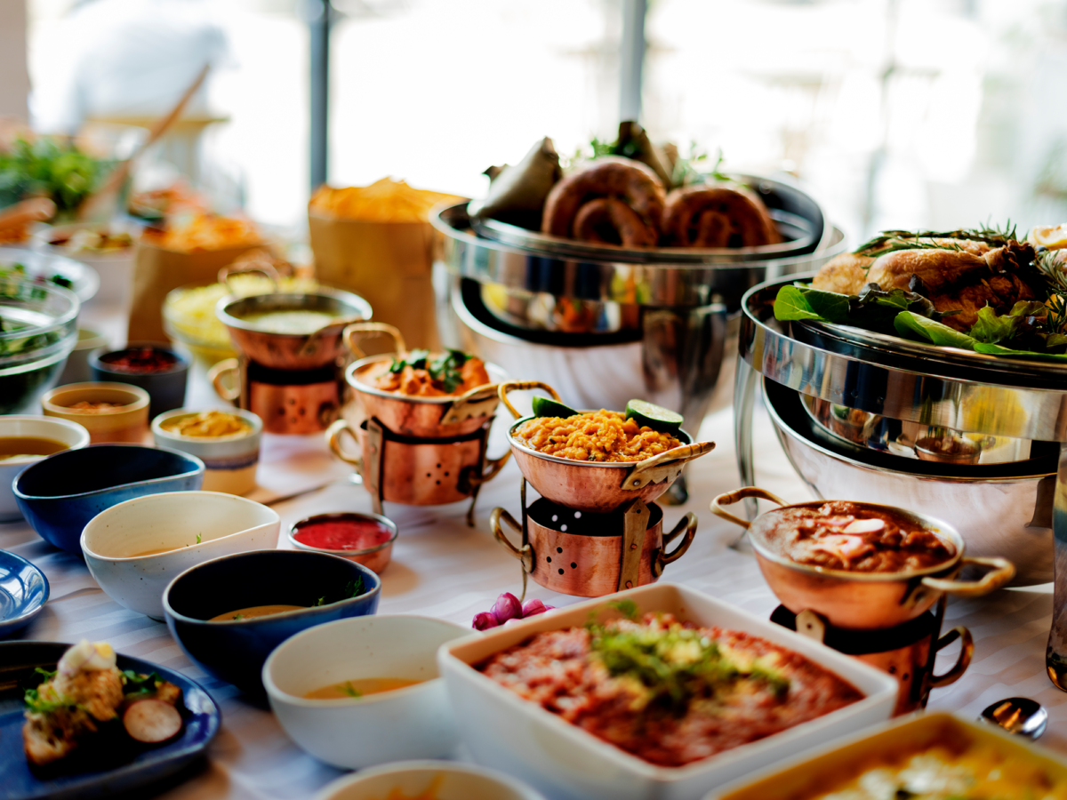 A close up of a catering setup with both hot and cold plates