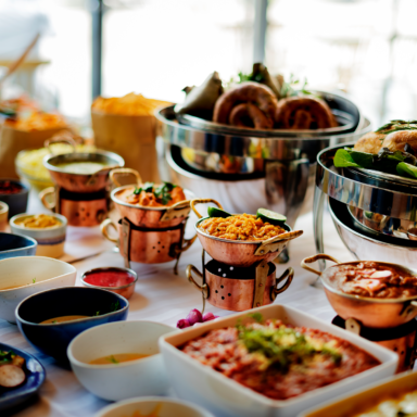 A close up of a catering setup with both hot and cold plates