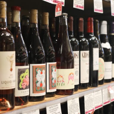 A shot of a row of wine bottles on the shelf at a Market