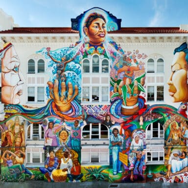 Front Facing View Of The Facade Of The Womens Building In The Mission Featuring Maestrapeace Mural
