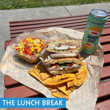 Unwrapped sandwich with corn salsa, plantain chips, soda