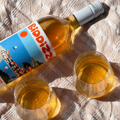 Bottle And Two Glasses Of Biddizza Skin Contact