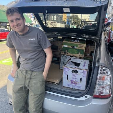 Bi-Rite team member helps load car for Compass Family Shelter.