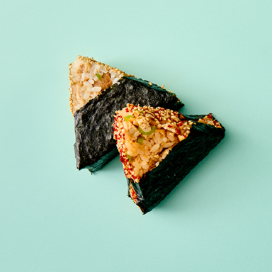 Two Pieces Of Onigiri Shot From Above On Teal